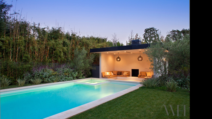 A big spanning swimming pool in the grassy area is perfect for the house