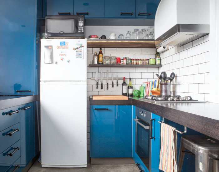 towel holder on blue kitchen cabinets