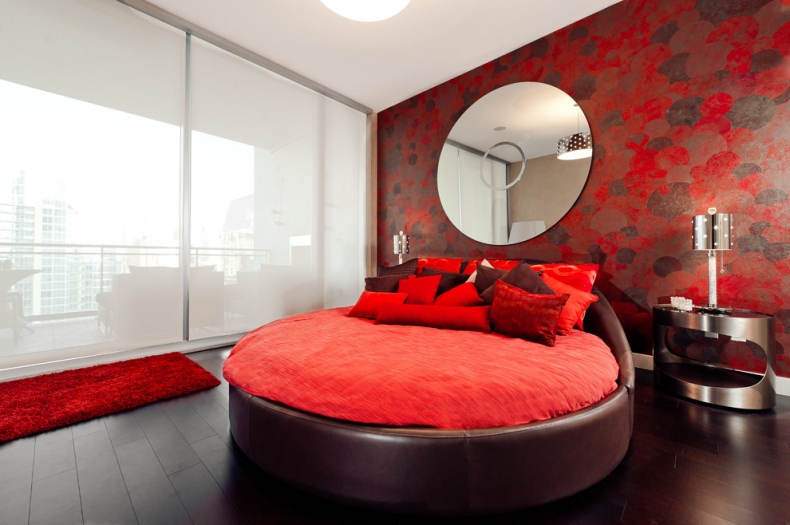 Round bed with the red bed spread 