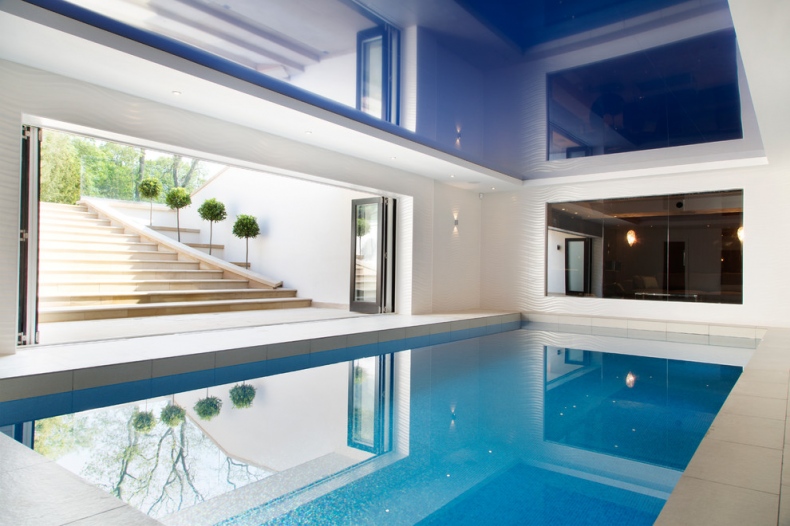 Stairs lead you down to an indoor swimming pool