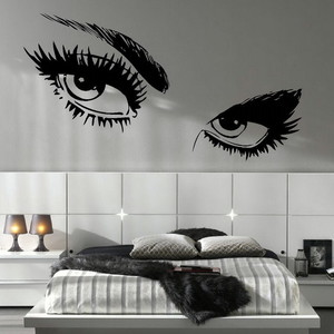 Bedroom with large eyes artwork