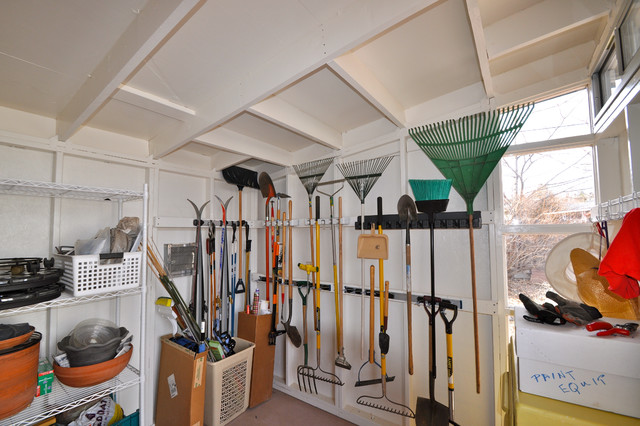Storage shed with tools mounted on the walls