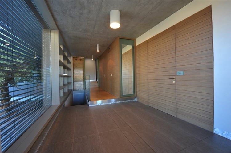 Thiva house interior with wooden floor and wall